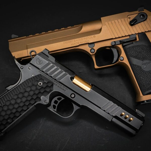 a gold and black gun on a black background