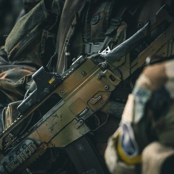 a close up of a rifle on a person's arm