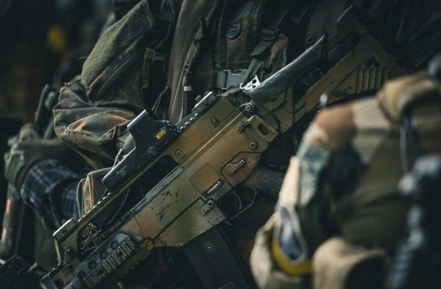 a close up of a rifle on a person's arm