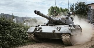 battle tank on green grass field during daytime